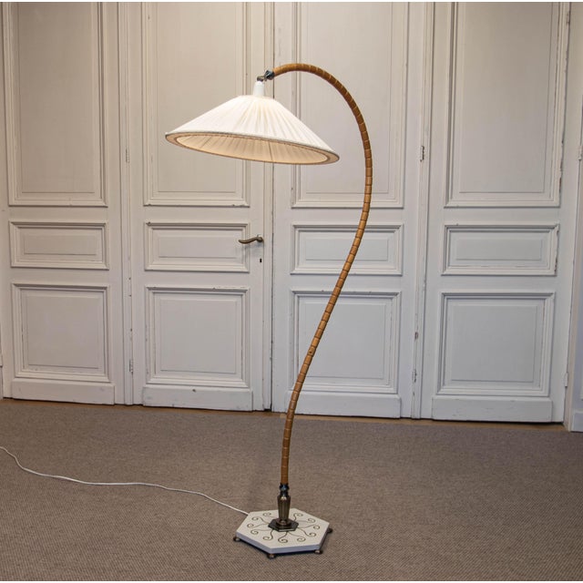 A striking 1940s Swedish Grace arc floor lamp, a highly decorative example of early Scandinavian lighting design from...