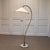 A striking 1940s Swedish Grace arc floor lamp, a highly decorative example of early Scandinavian lighting design from...