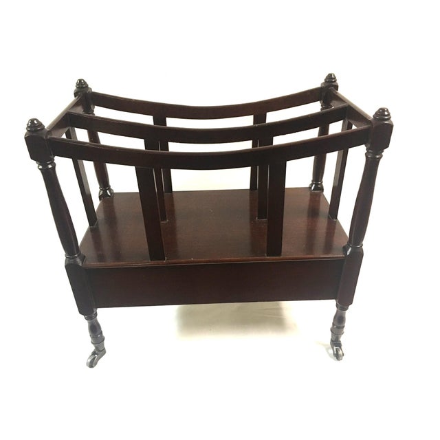 A Canterbury in the Sheraton style and featuring mahogany wood with two divisions and a drawer, raised on turned legs with...