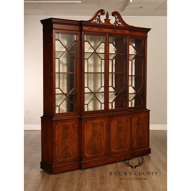 Distinguished Karges breakfront display cabinet crafted in the English tradition with richly figured mahogany veneers and...