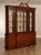 Distinguished Karges breakfront display cabinet crafted in the English tradition with richly figured mahogany veneers and...