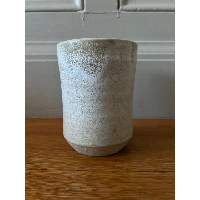 Small wide mouth Ceramic vase with irregular beige pattern. Its delicate color and plane shape makes it extremely...