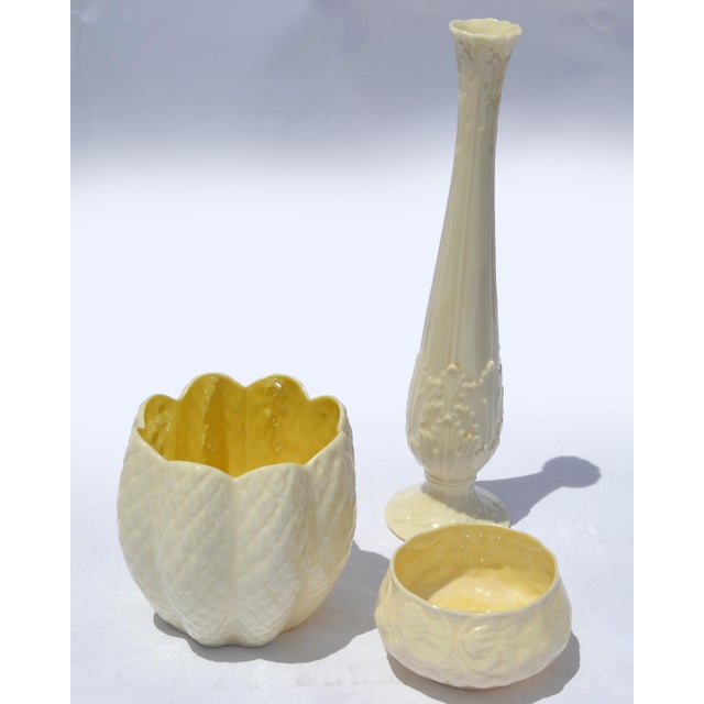 Set of 2 Early 20th Century Belleek Pottery cream-colored flower pot with a scalloped, textured exterior and a bright...