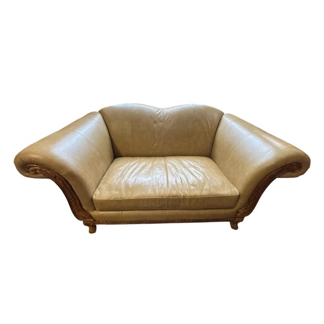 This elegant hand-carved leather loveseat offers timeless European-inspired style in a versatile 71-inch width....