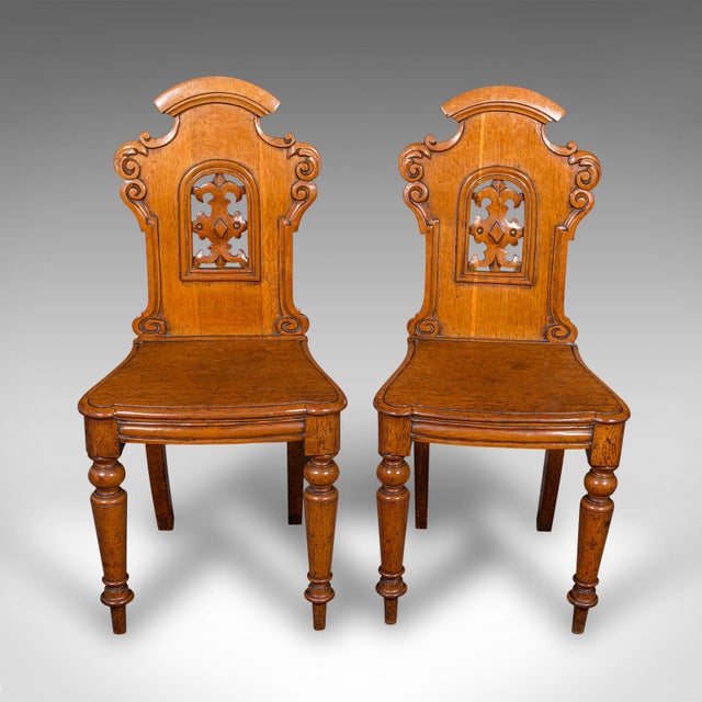 This is a fine pair of antique hall chairs. A Scottish, golden oak reception seat, dating to the late Regency period,...