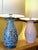 Pair of baluster-shaped ceramic table lamps, one with a midnight blue base, the other with a pink base, both decorated...