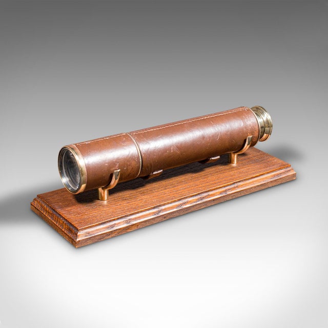 This is an antique 3-draw telescope. An English, leather and brass terrestrial refractor by Broadhurst, Clarkson & Co,...