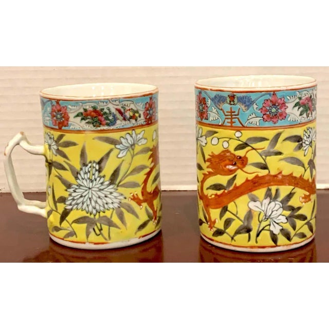Pair of 19th century Chinese Export Famille Verte yellow Dragon motif mugs, Each one decorated with a four toed dragon...