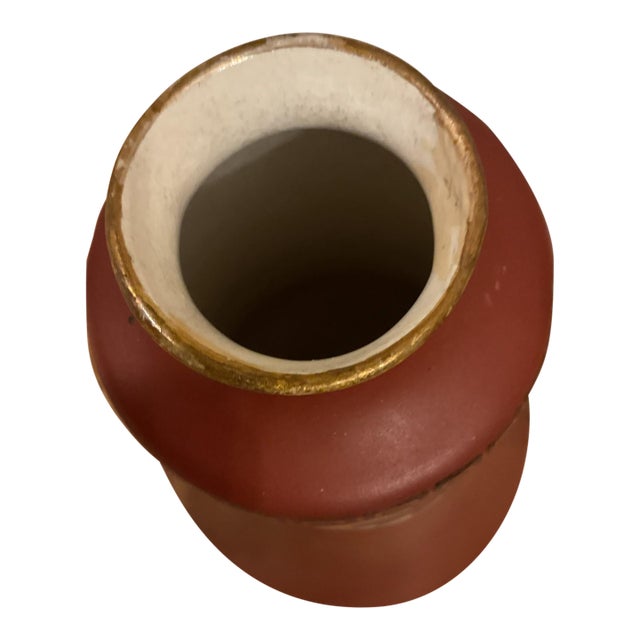 This antique Haynes Ware Illyrian vase from the late 19th century features a striking red color with an Art Nouveau style....