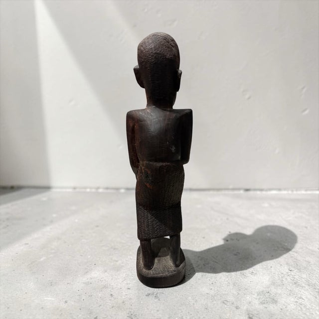 This striking mid-20th-century hand-carved wooden sculpture showcases traditional African tribal craftsmanship and elegant...