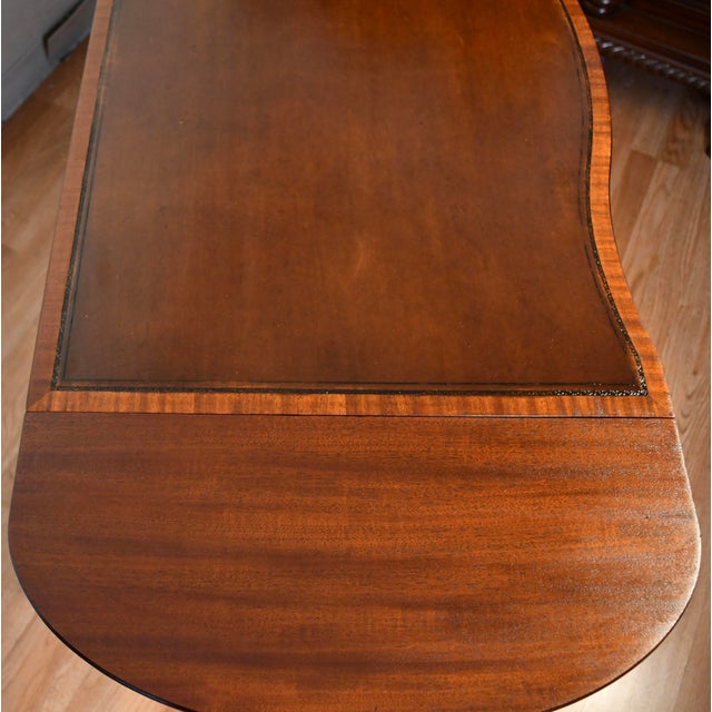 We are pleased to offer this beautiful English Regency style Drop-leaf sofa table, from the 1930s. This table is made of...