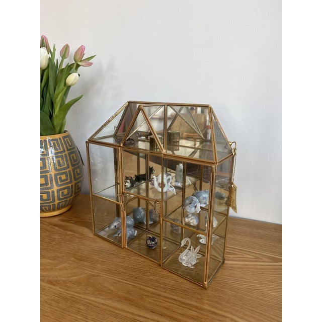 A 14-karat brass gold curio cabinet for that extra touch of extravagance. You can easily hang it on the wall or place it...