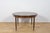 This round extendable dining table was produced by G-Plan in the 1960s. The table has profiled reinforced edges of the...
