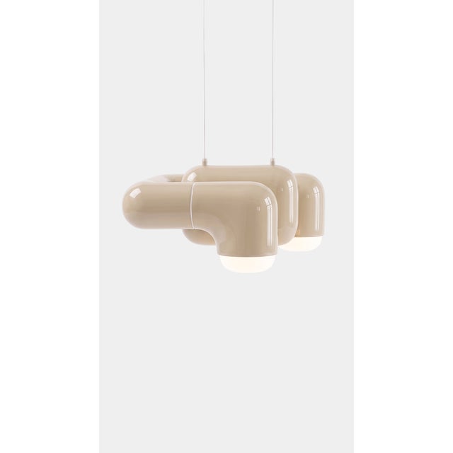 A pendant light with real character in a small footprint. Curved printed tiles interlock into a low, wide shade that seems...