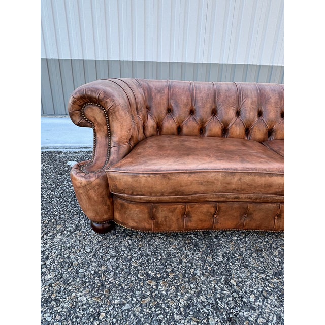 This Vintage English Chesterfield Sofa is similar to the Howard and Sons crescent chesterfield sofas with a beautiful hand...