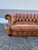 This Vintage English Chesterfield Sofa is similar to the Howard and Sons crescent chesterfield sofas with a beautiful hand...