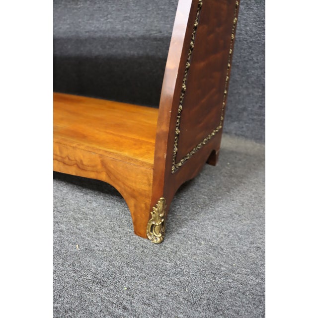 Elegant open etagère in the Neoclassical Louis XVI revival style, featuring a honed marble inset top and ornate brass...