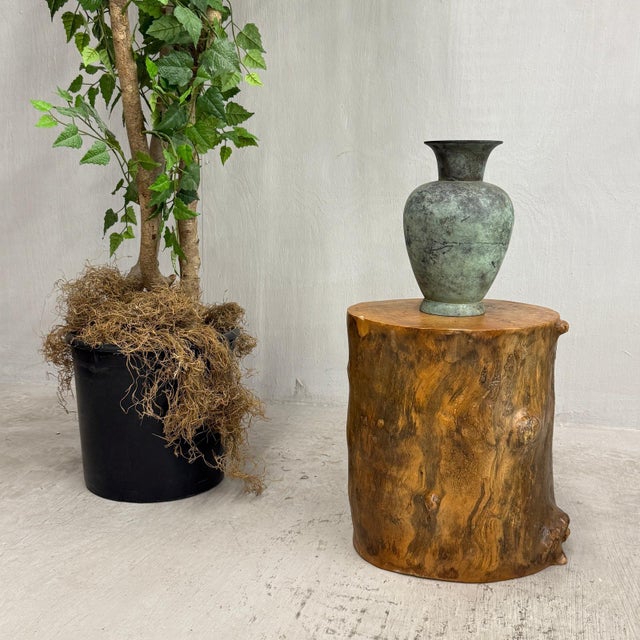 "About This Piece About This Piece This polished burlwood table glows with the warmth of sunlit amber, its surface alive...