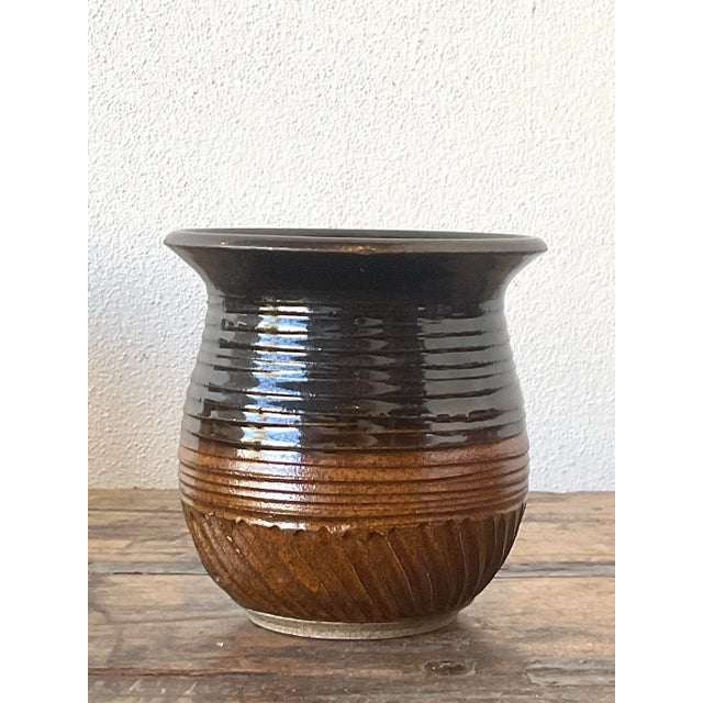 This vintage studio art pottery vase is a masterclass in texture and tonal depth, perfect for the collector seeking...