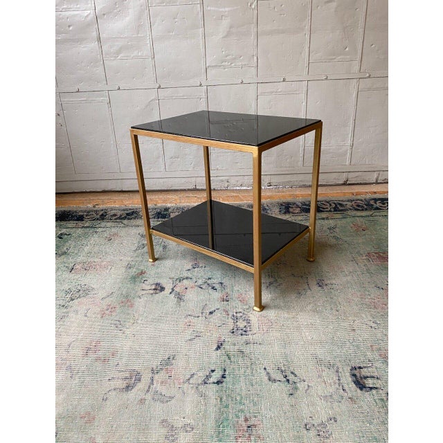 This well proportioned side table features an iron frame in a hand distressed gold finish with an undercoat of Venetian...