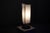 Table lamp with a round marble base, supporting three chrome-plated steel "masts," each equipped with an adjustable...