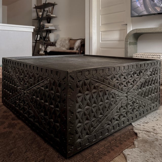 Discontinued Four Hands Maya coffee table handcrafted from reclaimed wood with intricate geometric carving inspired by...