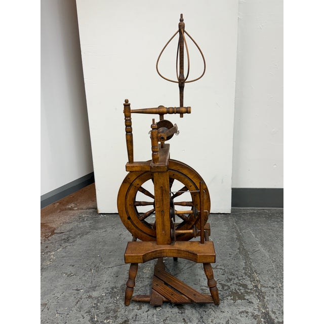 Design Plus Gallery presents an Antique Upright Wooden Spinning Wheel. The vertical frame supports a large drive wheel,...
