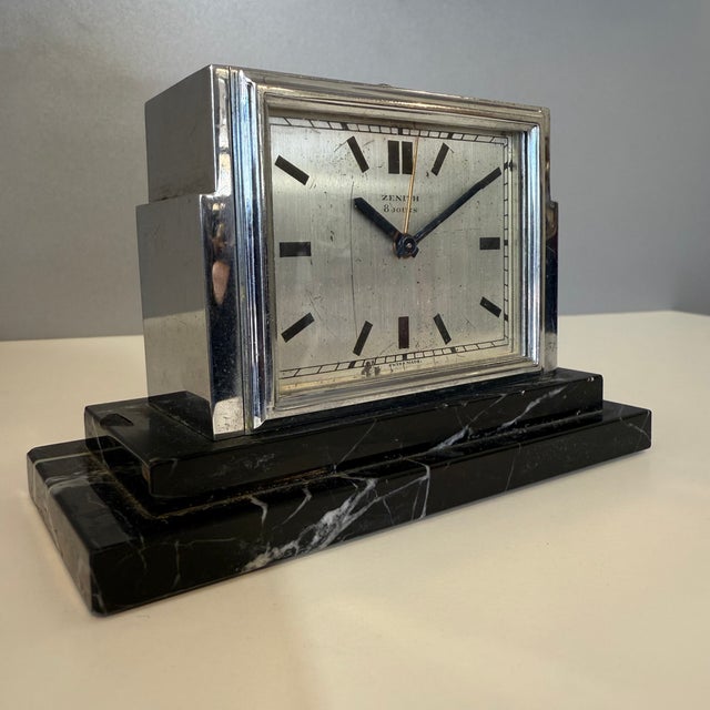 Rare table alarm clock Signed by Zenith, Switzerland Black marble base Steel frame In perfect working order 12.5 x 6 x 8...