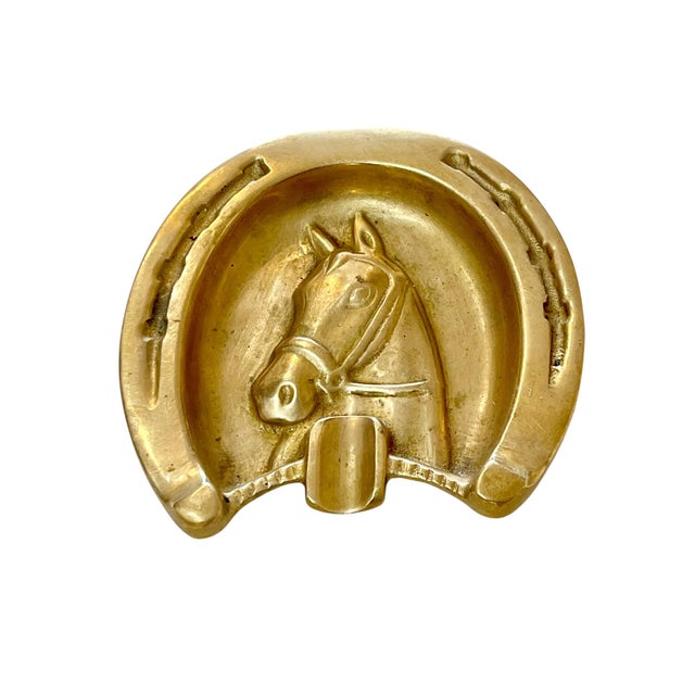 Vintage brass ashtray in the form of a horseshoe with horse in the center. Perfect for jewelry or keys. Sourced in France.