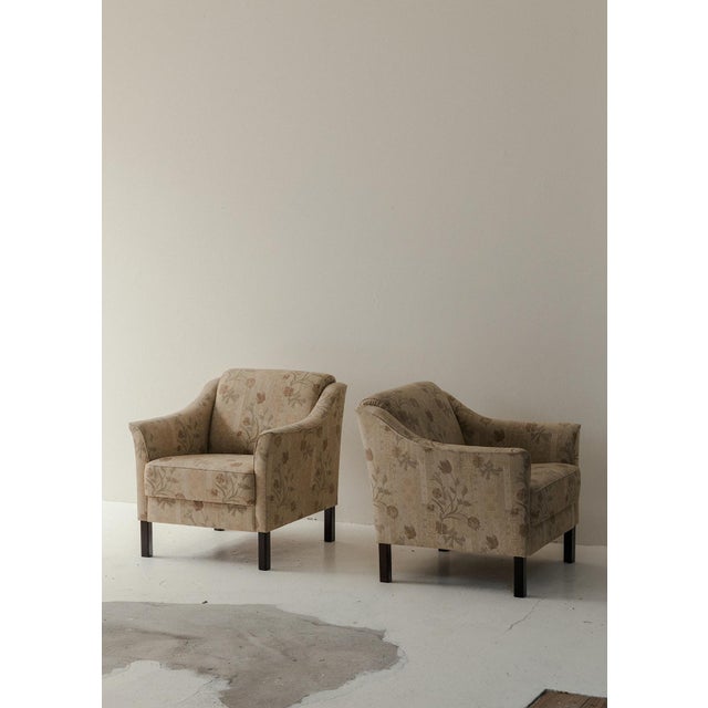 Set lounge chairs produced in Denmark around 1960. These comfortable chairs have dark stained wooden legs and a beautiful...