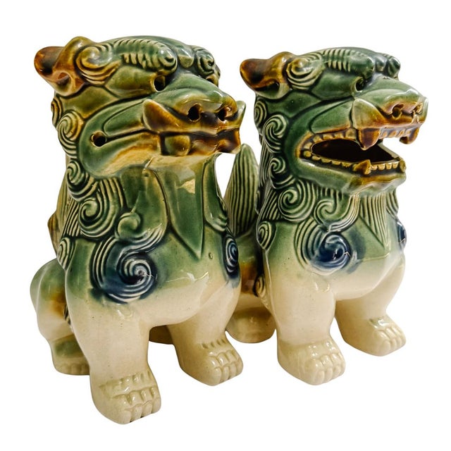 A beautiful pair of vintage glazed ceramic blue and green foo dogs. They are a matched pair, male and female, and are...