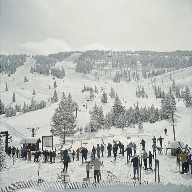 Skiing in Vail 1964 by Slim Aarons Slim Aarons Limited Estate Edition A group of skiers stand in line waiting for the ski...
