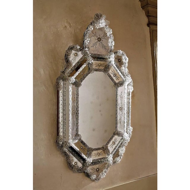A refined expression of Venetian artistry, this handcrafted mirror features exquisite hand-engraved motifs on antiqued...