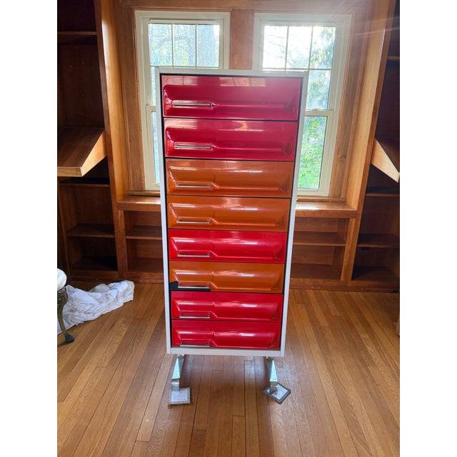Authentic 1970s Space Age tallboy dresser by Giovanni Maur for Treco. Features original molded plastic drawers in bold red...
