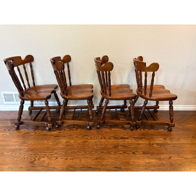 A distinctive set of four vintage Tell City Chair Company tavern chairs featuring beautifully sculpted solid wood seats,...