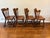 A distinctive set of four vintage Tell City Chair Company tavern chairs featuring beautifully sculpted solid wood seats,...