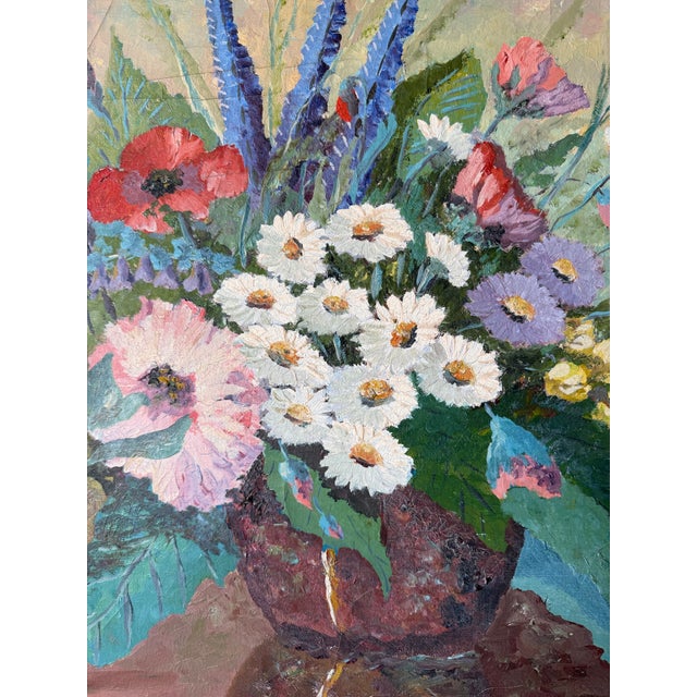 Beautiful 1960’s vintage still life oil on canvas featuring a vibrant floral arrangement in a rustic vase, accompanied by...
