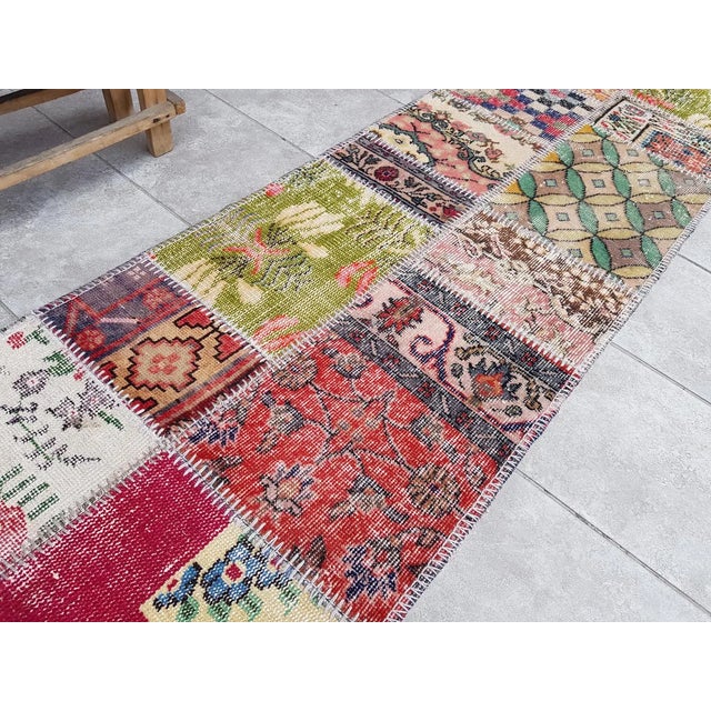 This is a vintage Turkish Oushak rug from the Mid 20th Century. The piece was hand-knotted.