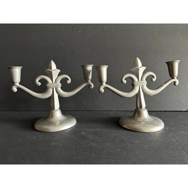 Pair of Art Deco candelabras likely from the 1920s-1930s. They are made out of pewter and have a central stem with a...