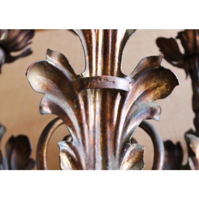 This splendid pair of three-light wall lamps is crafted from handcrafted wrought iron with a dark burnished finish,...
