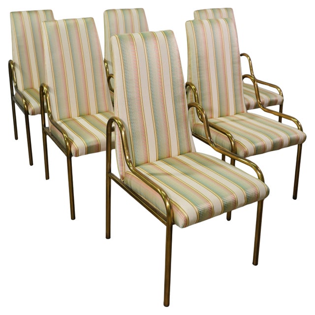An exceptional set of six Mid-Century Hollywood Regency brass dining chairs by Mastercraft. The chairs feature sculpted...