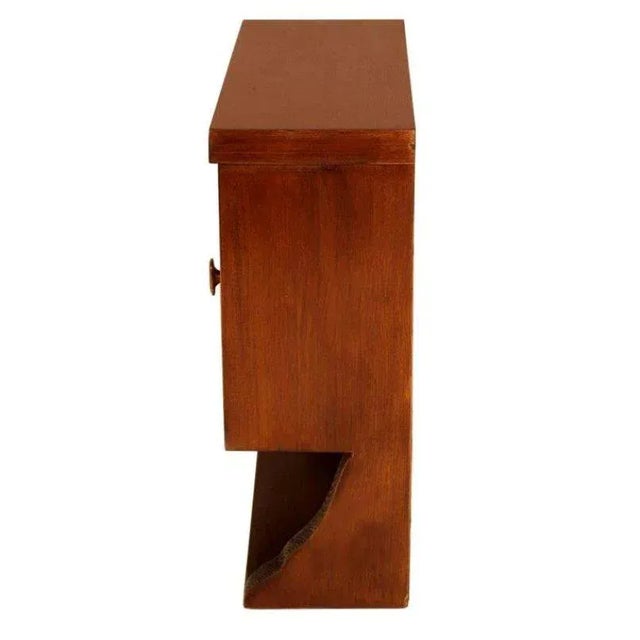 This small Italian Art Deco wall display cabinet from the 1930s is made of wax-polished oak with a beveled crystal door...