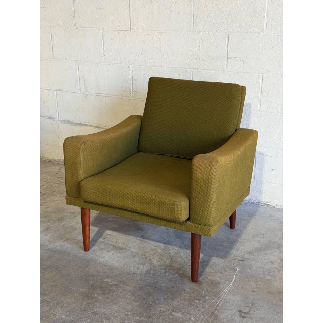 This lounge chair features a structured frame with padded track arms and an angled backrest. Its comfortable profile...