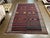 Handwoven Persian kilim flatweave rug featuring a wide striped field with horizontal bands of geometric and tribal motifs....