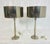 A sleek and elegant pair of nickel-plated table lamps featuring tall, tapered columns and coordinating nickel-finished...