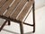 This antique industrial stool in pine wood and iron is an industrial seat with a tubular iron frame and a pine slatted...