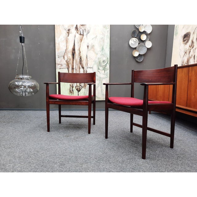 Offered are two understated armchairs by Kurt Østervig. Manufactured by Sibast of Denmark. Made of solid teakwood. These...