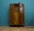 A 1930s Art Deco wardrobe in figured oak with a serpentine front. The doors feature a bold tiger oak veneer with a strong...