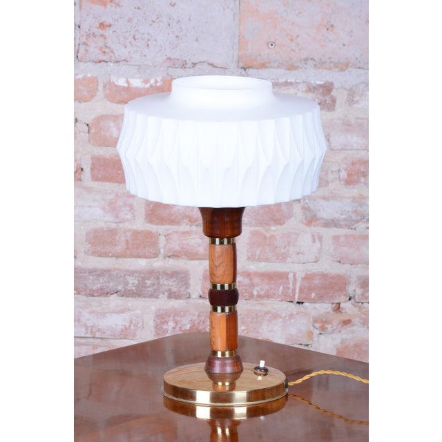 This 1960s table lamp is a stylish example of Czechoslovak design, which skillfully combined various materials at the time...