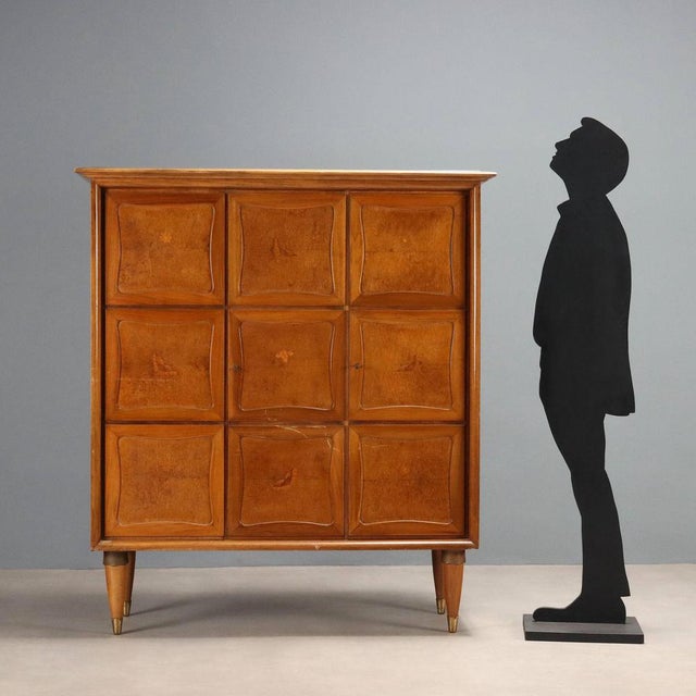 Sideboard with hinged doors in walnut and burl veneer, featuring inlaid decorations. The top is marble and the legs have...